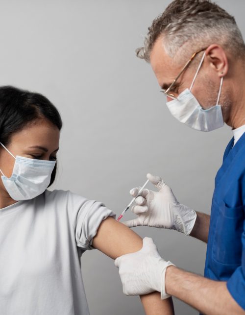medium-shot-woman-with-mask-getting-vaccinated